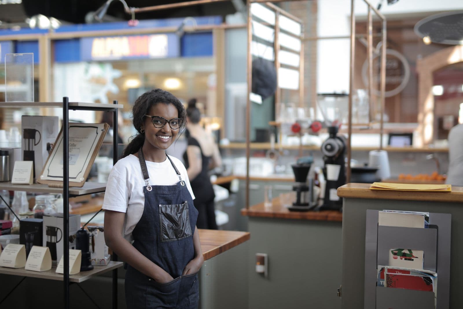 Cafe owner standing behind the counter of her shop