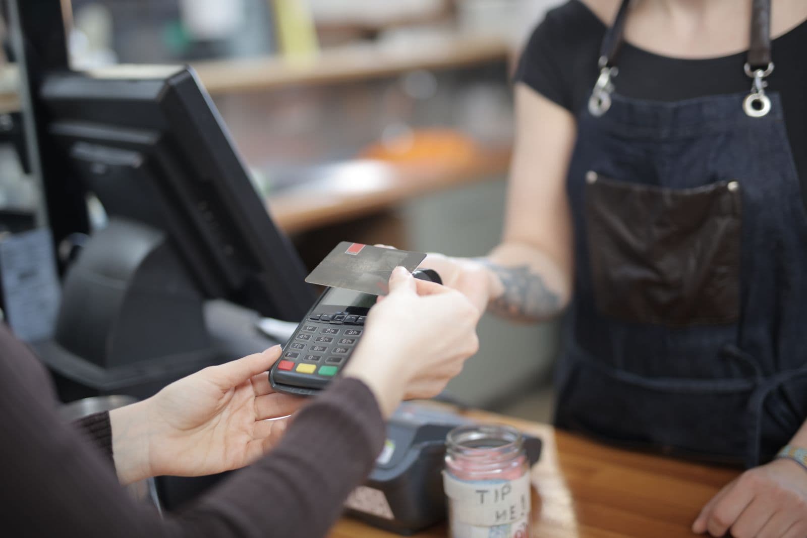 Customer paying by card at a store counter terminal