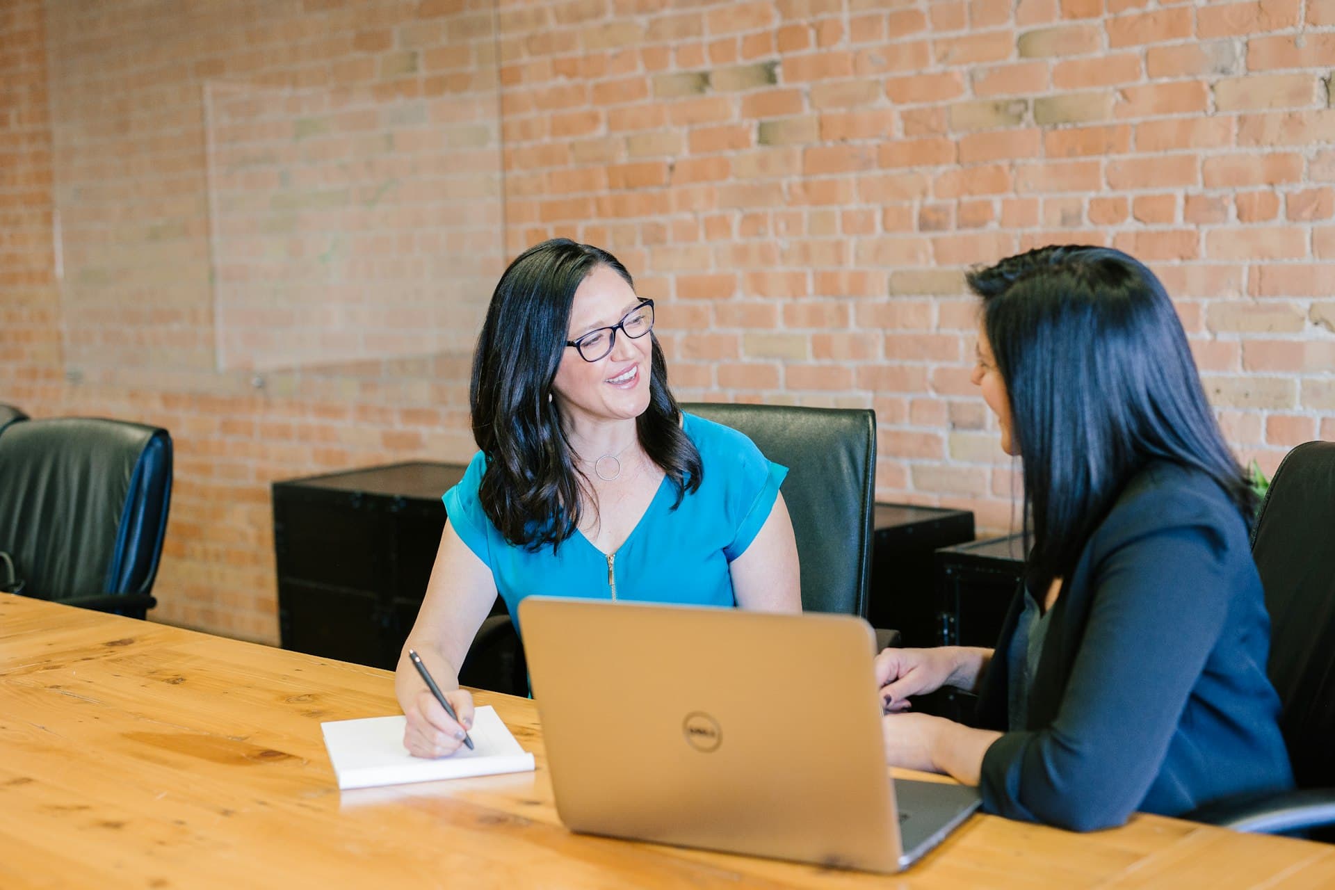 Business owner and advisor talking across a desk