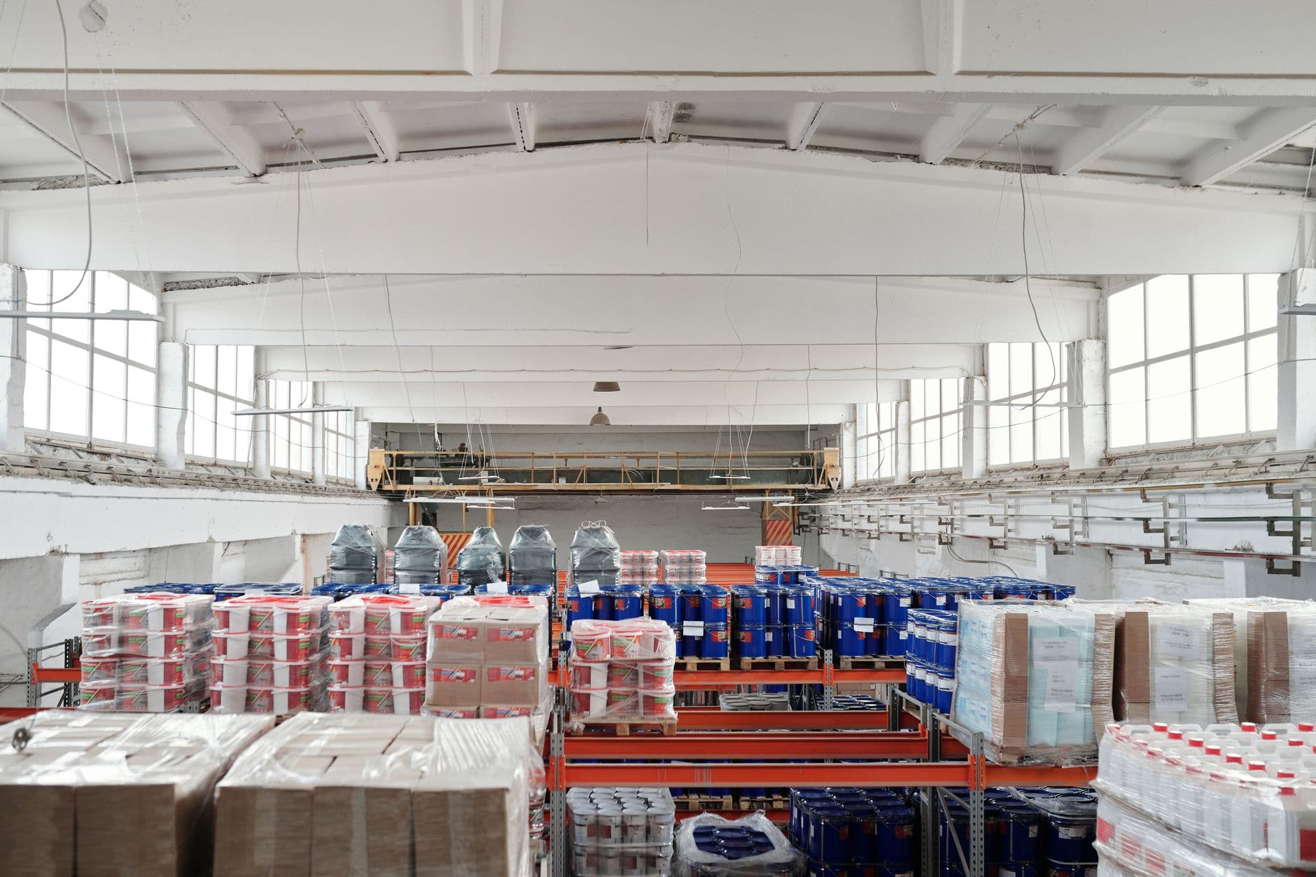 A worker checking pallets on a warehouse floor in a southern Ontario manufacturing business.